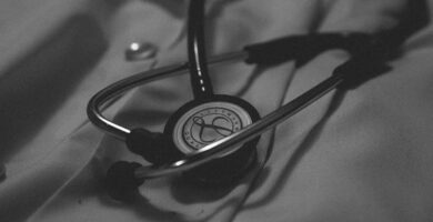 a black and white photo of a stethoscope on a bed