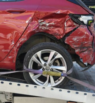 a red car is on a flatbed tow truck