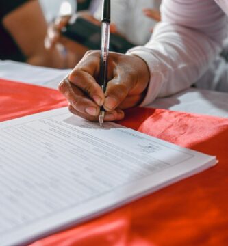 a person writing on a piece of paper